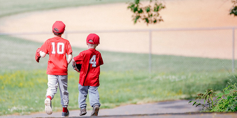 Two Childern Running to a Baseball Field